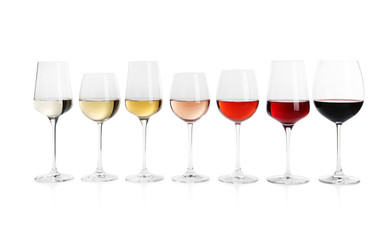 Row of glasses with different wines on white background