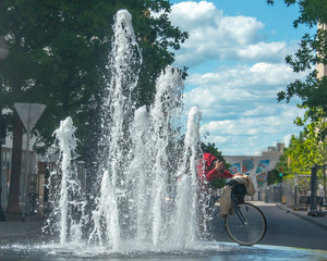 Cyclist Cooling off in Fountain