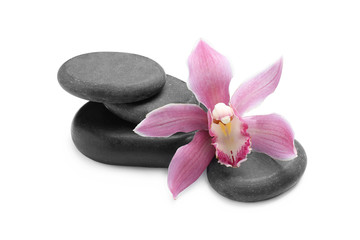 Obraz na płótnie Canvas Beautiful orchid flower and spa stones on white background