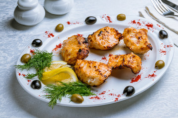 shish kebab from sturgeon on white plate