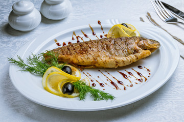 fried trout on white plate