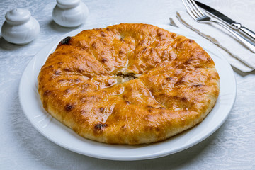 Ossetian pie with meat on white plate