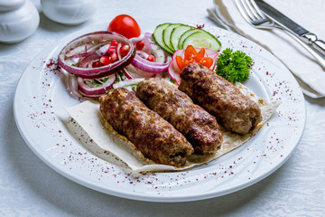 Lamb Lula kebab on white plate
