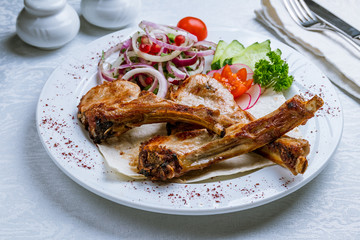 Rack of lamb on white plate
