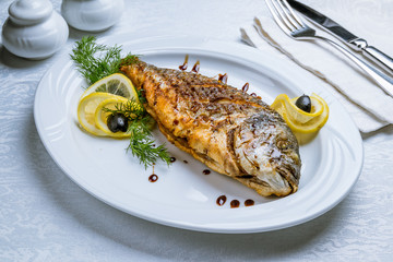 Dorado on grill on white plate