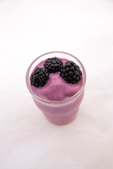 Acai Smoothie with fresh blackberries in the glass cup