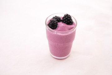 Fototapeta na wymiar Acai Smoothie with fresh blackberries in the glass cup