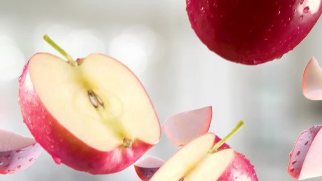 Red Apple with Slices Falling on Kitchen Background