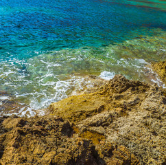 Yellow rocky shore and amazing blue sea