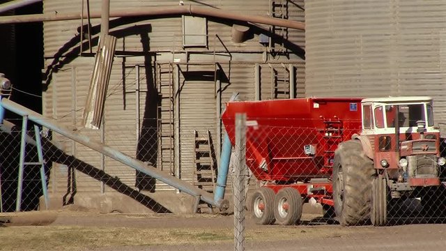Workers And Tractor Working On Storage Silo For Agricultural Cereal Products.