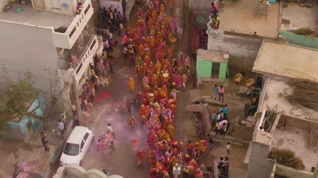 Color battle at the holi festival in India, 4k aerial shot