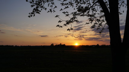 Beautiful Sunset over a field with clouds 