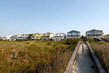 Fototapeta na wymiar Vacation beach rentals on the green sand dunes, Sunset Beach, North Carolina