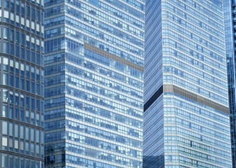 Plakat close up on modern office building with blue glass windows