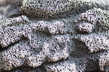 Black and porous concrete surfaces that are large and rough