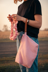 Outdoor atmospheric lifestyle photo of young beautiful  darkhaired woman   smiling and knitting...