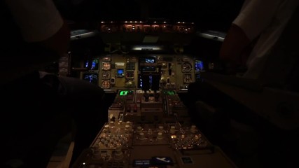 Two pilots in the cockpit of a Jet airplane Airbus during a night fligth
