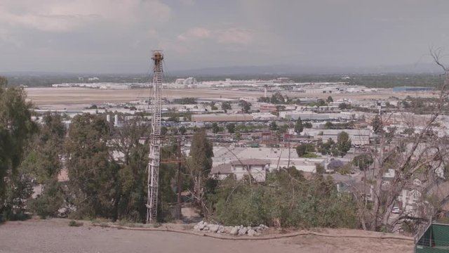 Tower in FG with airport in the distance.