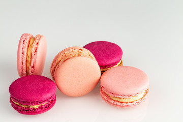 French pink macarons or macaroons stack, side top view on a white background with copyspace.