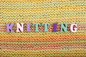 Knitting. Knitted Fabric Texture. Word composed from ABC alphabet letters.