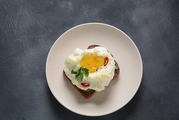 Delicate baked egg. Orsini eggs in the cloud. French breakfast.Cloud egg on toast 