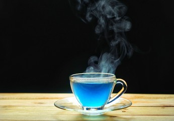Hot tea cup in a glass on wood table. Hot drink . Copy space.