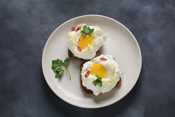 Delicate baked egg. Orsini eggs in the cloud. French breakfast.Cloud egg on toast 