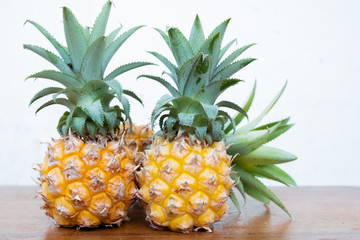 Fresh pineapple on a brown wooden.