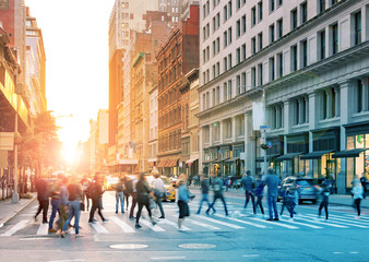 Crowds of people walking across the busy intersection of 23rd Street and 5th Avenue in Midtown Manhattan, New York City