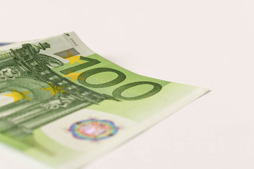 100 Euro banknote on a light background. Close up. The concept of savings.