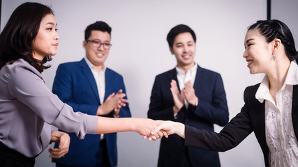 Fototapeta na wymiar Business people shaking hands, between meeting in seminar room