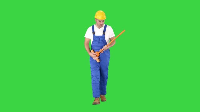 Cheerful man playing on the swob like it is a guitar on a Green Screen, Chroma Key.