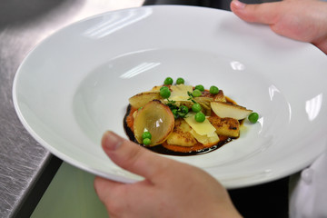 close up of hand holding a fancy dish