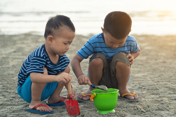 asian boys playing on the beach