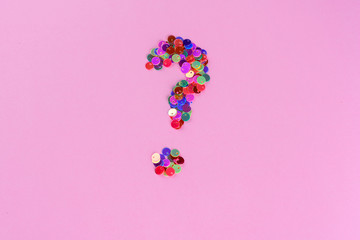 Holographic glitter question mark from sequins.Copy space.