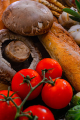 The arrangement of various breads and vegetables is still,bread,tomato focus on Portobello Mushroom