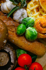The arrangement of various breads and vegetables is still,cinnamao roll,garlic,Brussels Sprouts, tomato portable mushroom focus on Brussels sprouts