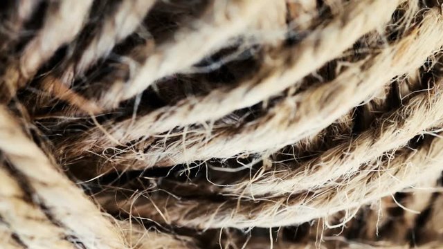 Natural string rope, twine, texture macro shot. Slow rotation, slow motion. Selective focus.