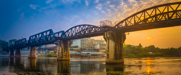 The bridge on the river Kwai at sunrise. Railway in Kanchanaburi, Thailand. Panorama