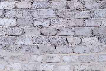 plastered brick wall with whitewash,with sloppy brick and crumbling whitewash,taken on a Sunny spring day