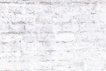 plastered brick wall with whitewash,with sloppy brick and crumbling whitewash,taken on a Sunny spring day