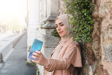 Beautiful Muslim women uses smart phone