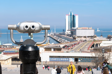 Coin operated binocular viewer overlooking the cityscape, harbor, sea and skyline of Odessa. Popular tourist area and place of recreation and meetings of townspeople.