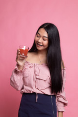 Young Asian woman drink tomato juice.