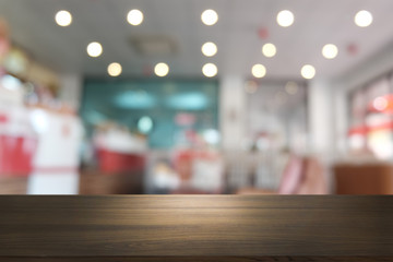 Empty dark wooden table in front of abstract blurred bokeh background of restaurant . can be used for display or montage your products.Mock up for space.