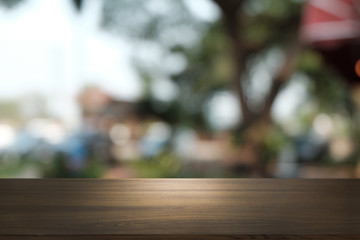 Empty dark wooden table in front of abstract blurred bokeh background of restaurant . can be used for display or montage your products.Mock up for space.