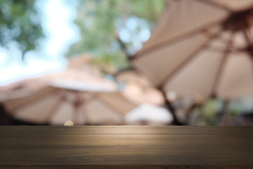 Empty dark wooden table in front of abstract blurred bokeh background of restaurant . can be used for display or montage your products.Mock up for space.