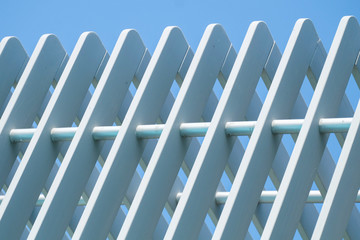 white fence and blue sky.