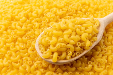 Pasta background with wooden spoon.