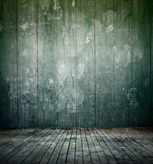 Empty dark room interior with old mottled doodles concrete wall and dirty wooden floor for texture background.